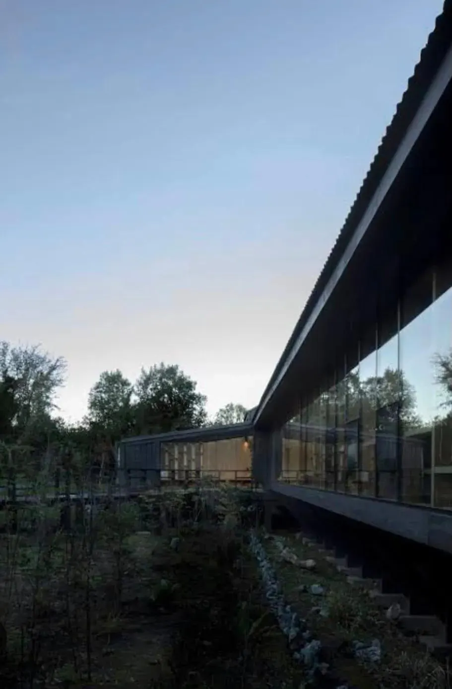 Fachada de vidrio y madera al atardecer